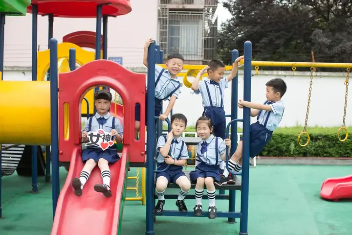 Kindergarten children playing together outdoors at kindy